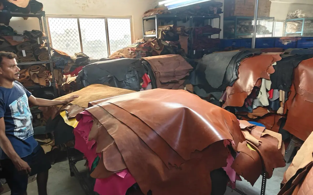 A cutter selecting a hide from the stack in the Revati Craft hide store