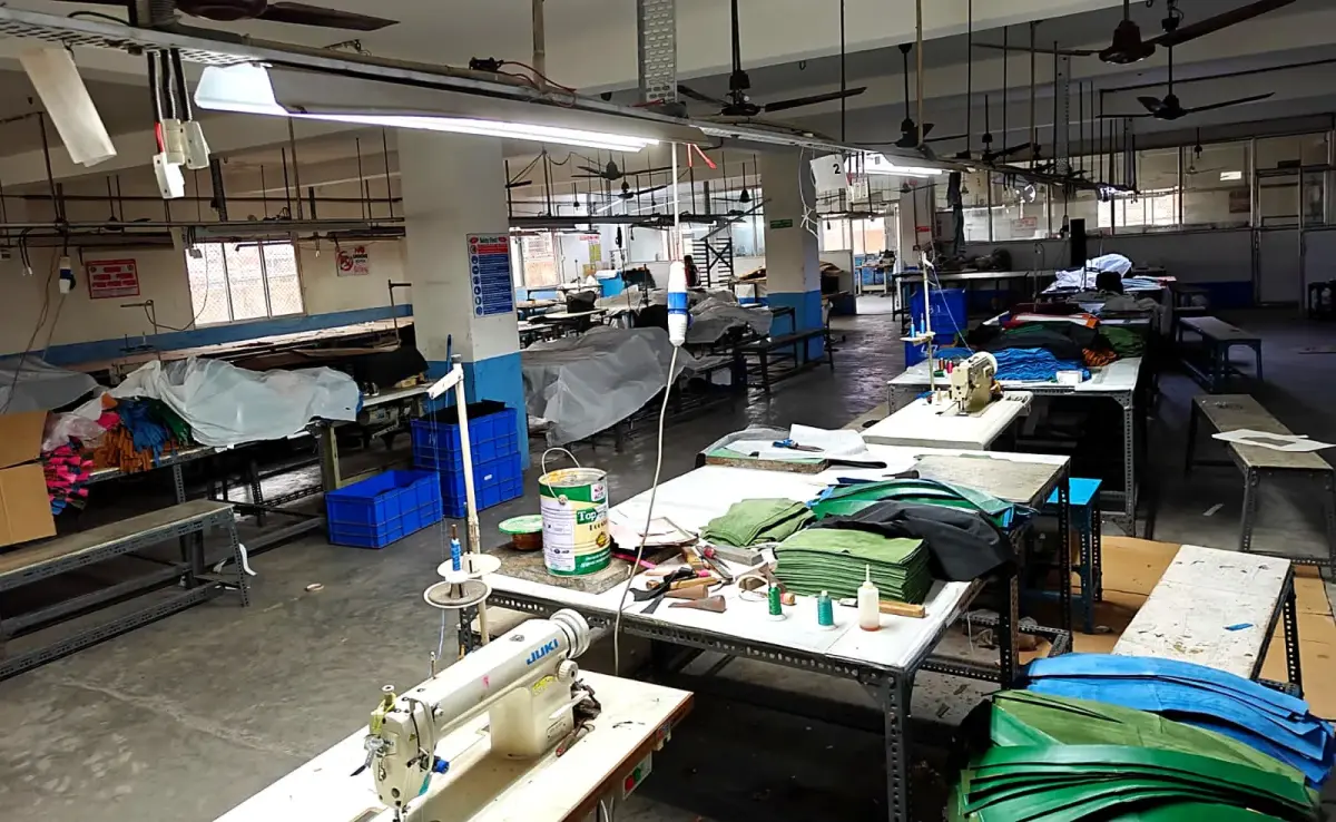 The stitching floor — flat-bed and post-bed machines arranged by operation.